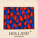 Red tulips on blue background light tote bag